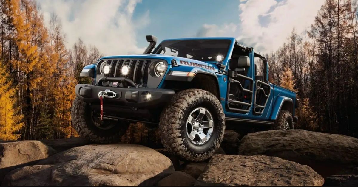 Blue 2021 Jeep Gladiator Rubicon Climbing Rocks