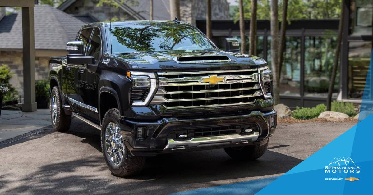 Black 2024 Chevrolet Silverado 2500 HD Parked in Front of a House in The Woods | Sierra Blanca Motors