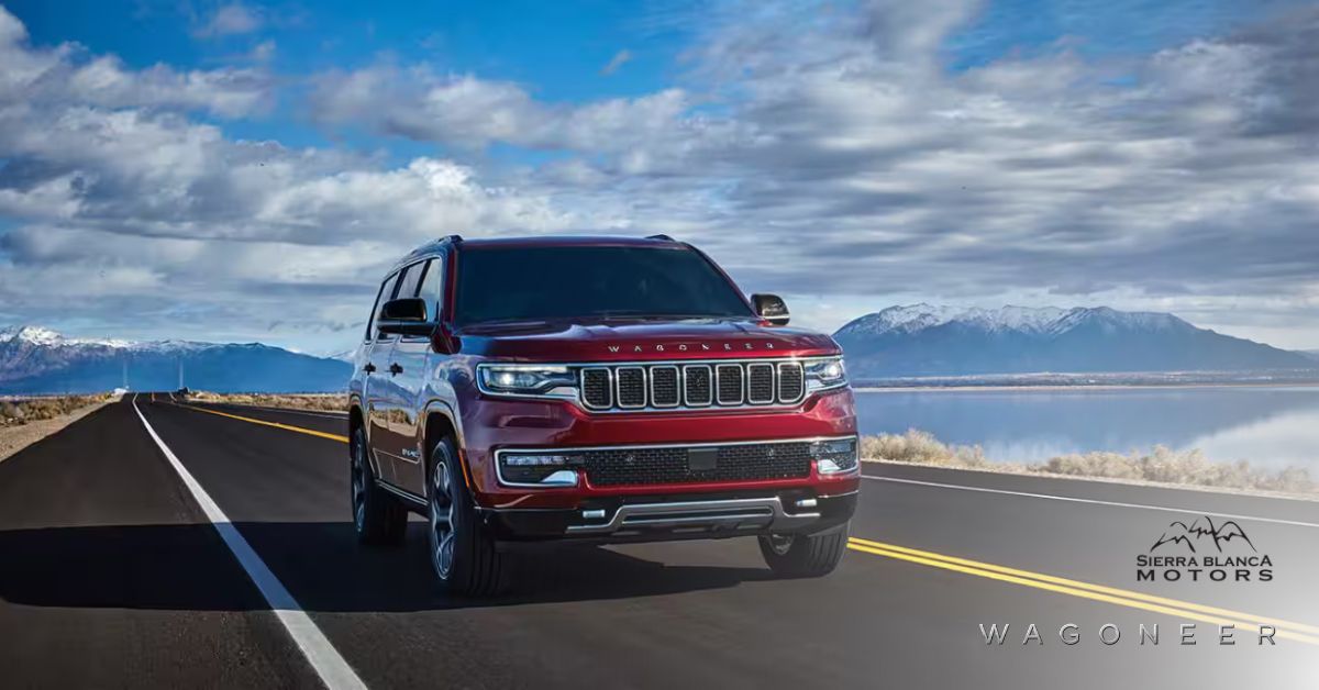 Red 2024 Wagoneer Driving Down The Road With a Lake with Snow Cap Mountains and Clouds in the Background | Sierra Blanca Motors