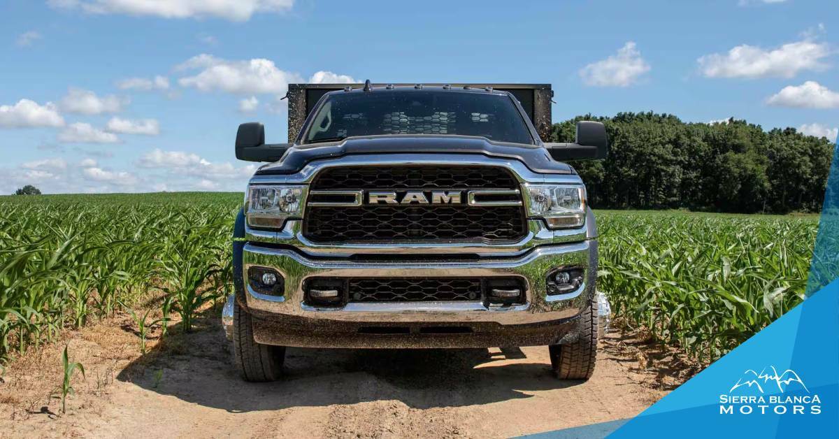 2024 RAM Truck Towing a Trailer in a Corn Field With A Blue Sky, Clouds, and Trees in the Background | Towing For Agriculture | Sierra Blanca Motors