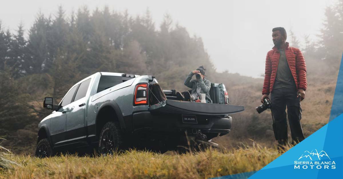 Man with items in bed of truck. truck owner essentials. Sierra Blanca Motors.